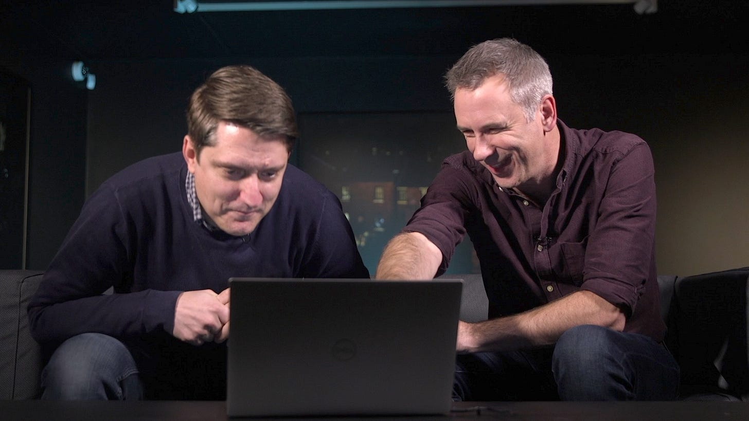 Mike and Spen laghing at a laptop screen