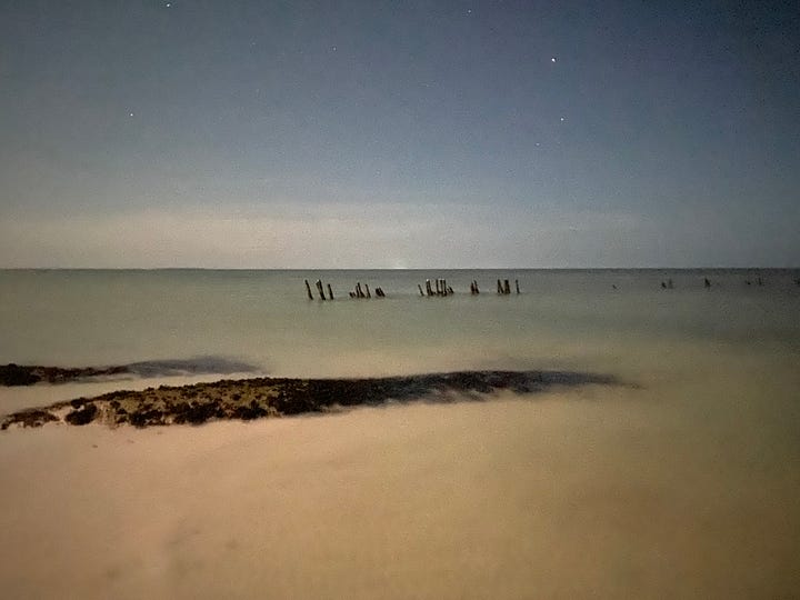 photos of sunsets and beach scenes after dark in Holbox, Mexico. The nighttime beach scenes appear to have been taken during the daytime, but because of the phone camera's ability to regulate light, the photos look like they were taken during the day. 