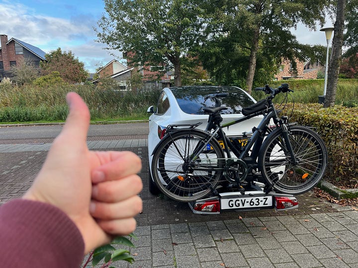 Bike rack on a Tesla Model Y. Sleeping mat inside Tesla Model Y.