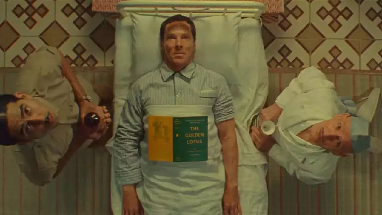 Dev Patel, Benedict Cumberbatch and Ben Kingsley all look up at the camera above them 