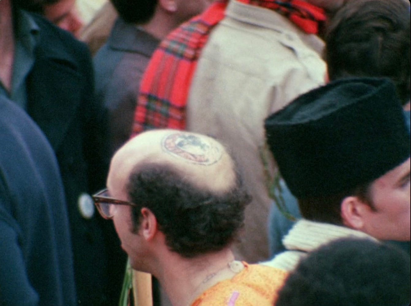 a bald man with a painting on his head a bald man with a painting on his head