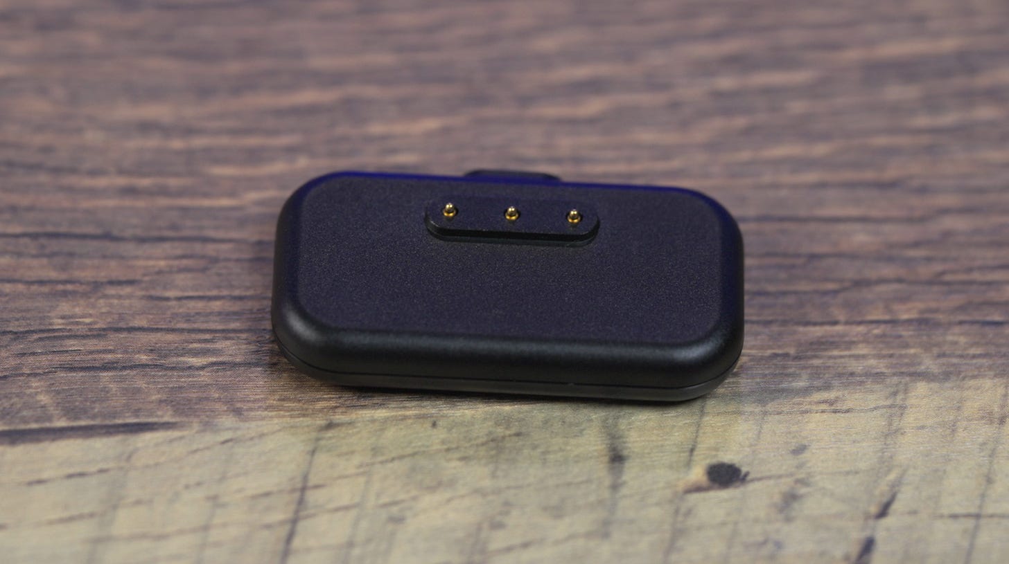 Steam Controller 2026 with charging puck — the magnetic puck attaches to the back of the controller for wireless connectivity and charging