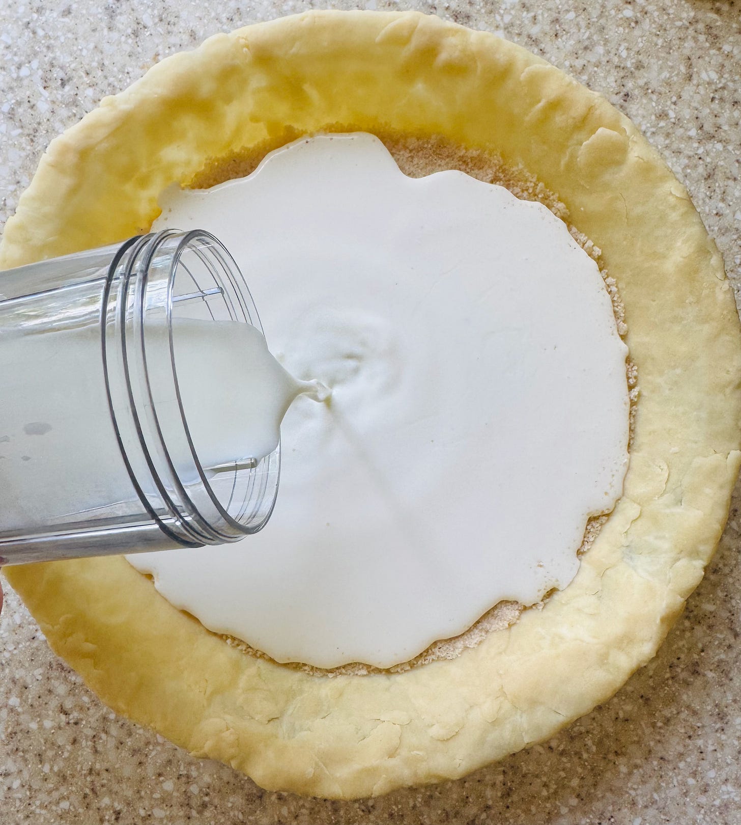 Pouring cream and milk over the dry filling mixture in an unbaked pie shell — Helen's Old Fashioned Cream Pie in progress. Pouring cream and milk over the dry filling mixture in an unbaked pie shell — Helen's Old Fashioned Cream Pie in progress.