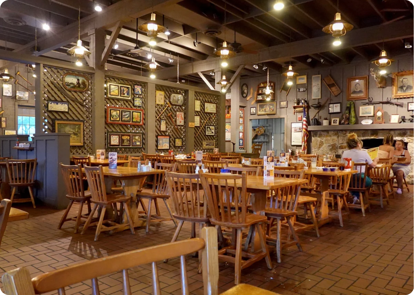A Cracker Barrel empty store floor, full of empty tables, one family A Cracker Barrel empty store floor, full of empty tables, one family