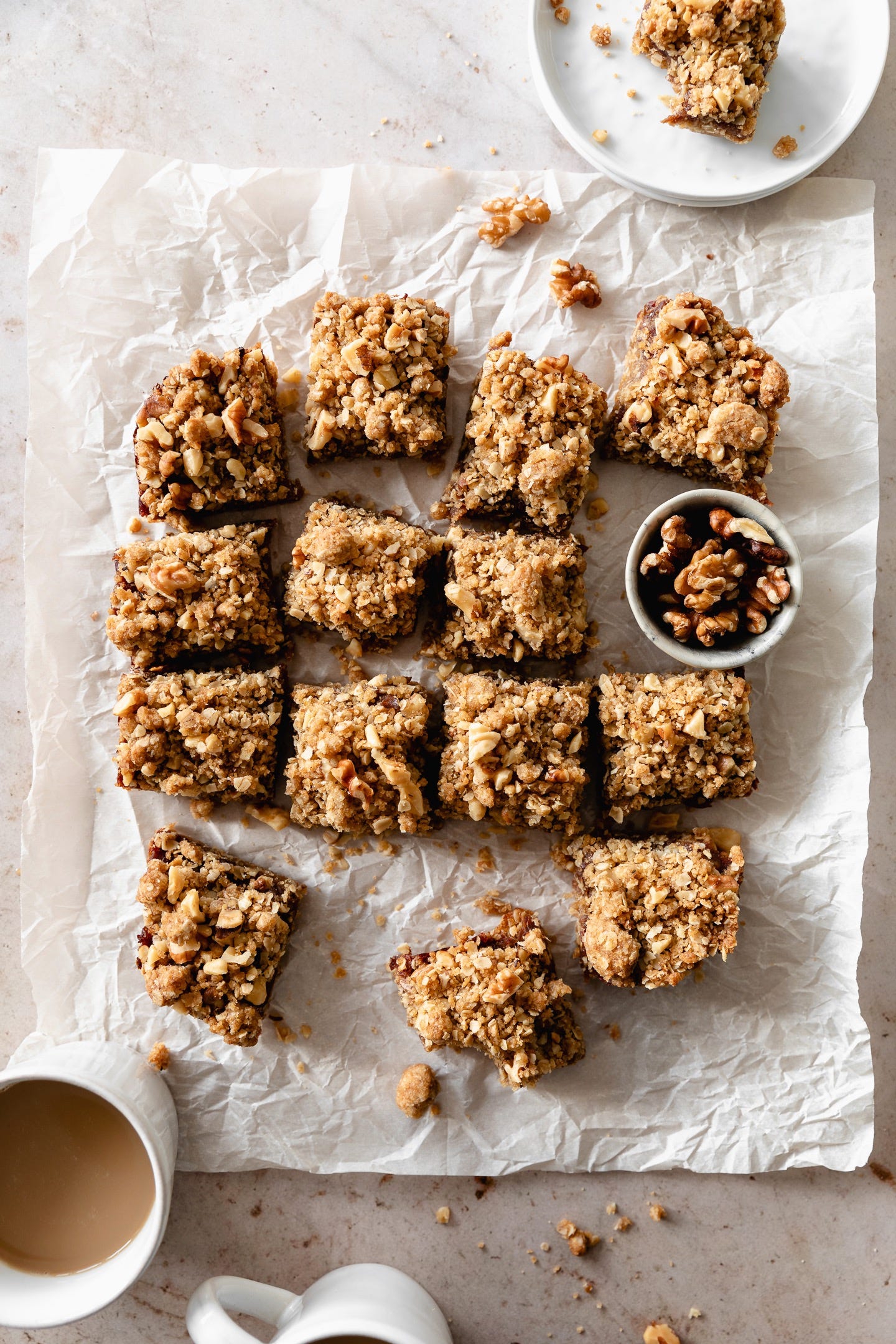 Vegan date walnut bars cut into squares on parchment paper