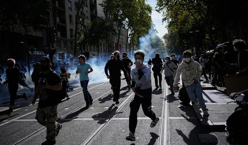 Students run out the teargas during a protest against under-resourced schools in Lyon, France, Friday, Oct. 2, 2026. (AP Photo/Laurent Cipriani) Students run out the teargas during a protest against under-resourced schools in Lyon, France, Friday, Oct. 2, 2026. (AP Photo/Laurent Cipriani)