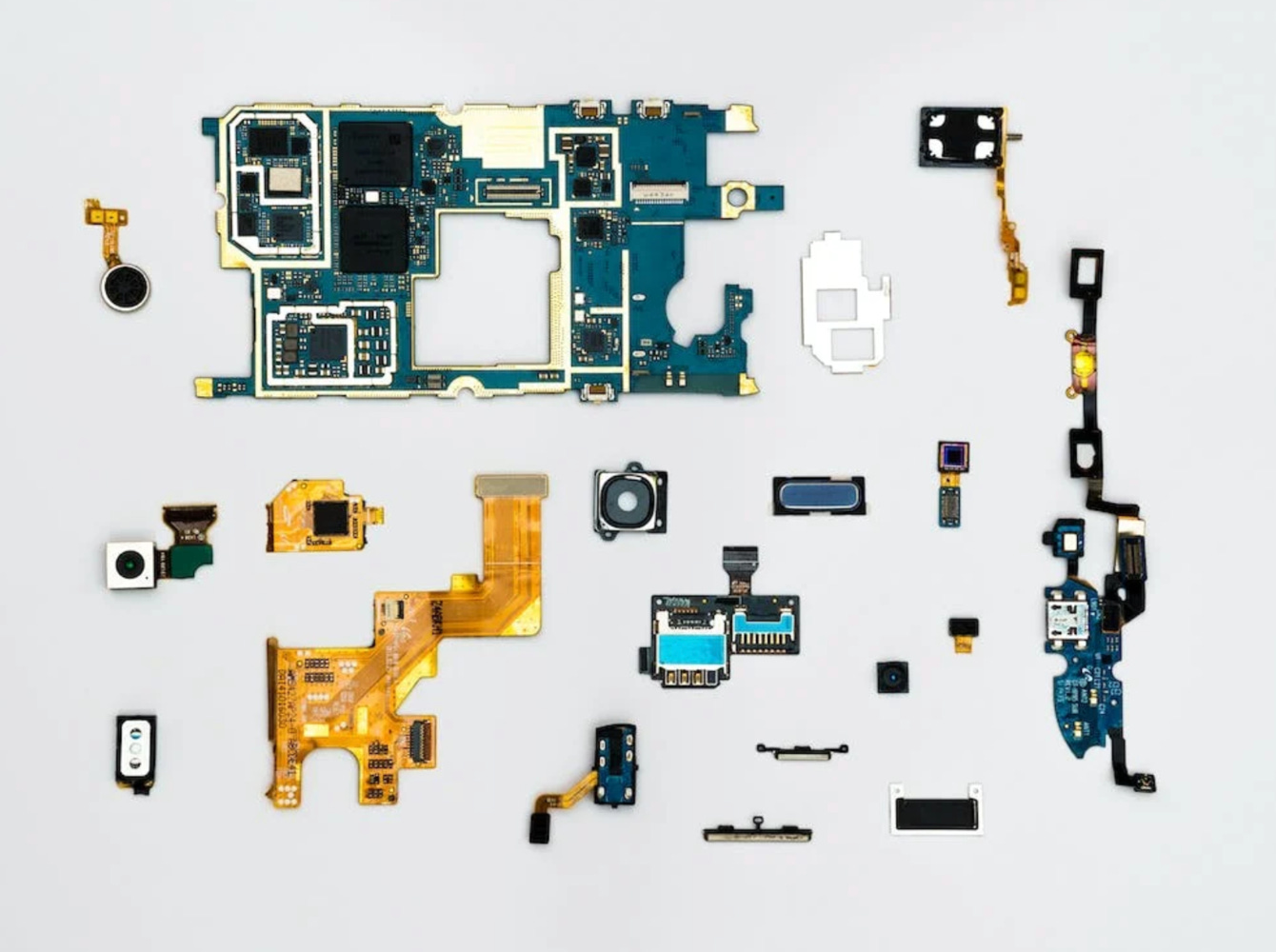 a motherboard taken apart and on a white background