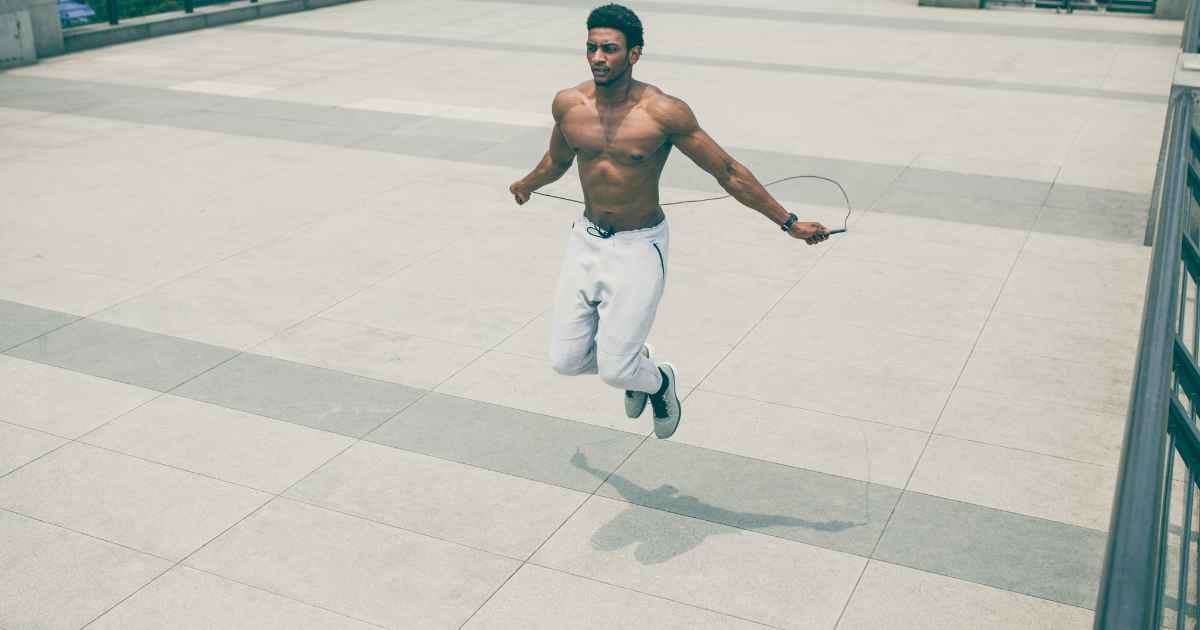 man doing jump rope exercises outside
