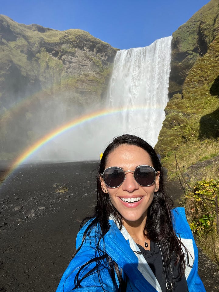 Counter-clockwise from top left: woman near base of the Seljalandsfoss waterfall as it pours into a small lake; selfie photo of woman near base of the Skogafoss waterfall, with a rainbow behind her and in front of the waterfall; selfie photo of woman from a view point with Fjadrargljufur canyon below and behind her; selfie photo of woman with strong winds blowing up from the Gullfoss waterfall behind and below her.
