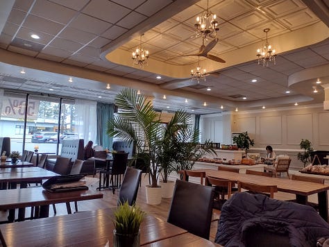 Bakery case, buns, interior of bakery with chandeliers