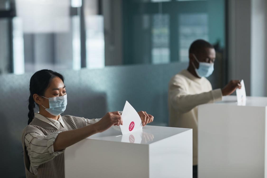 Free People Casting Their Voting Ballots in a Box Stock Photo