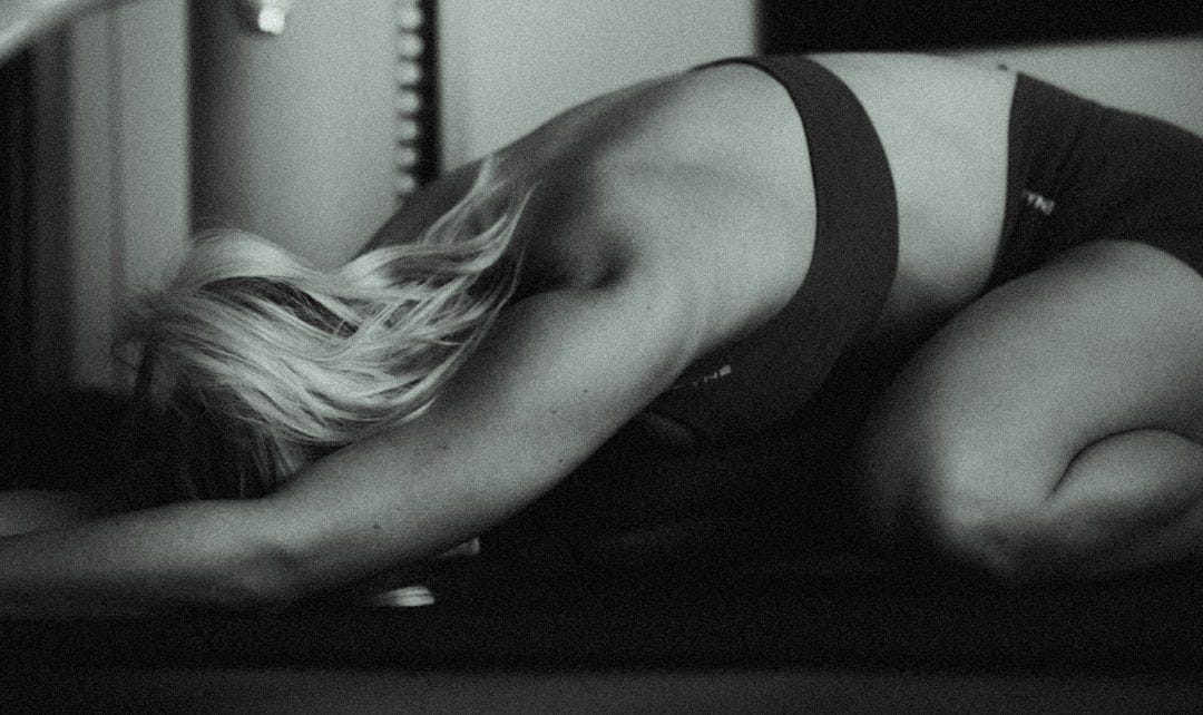 A black and white photo of a woman in lingerie
