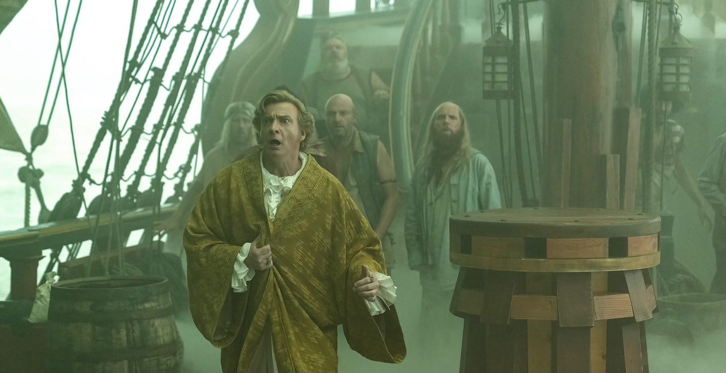 Screen shot from our Flag Means Death. Stede and the crew on deck, shocked by the surrounding fog.