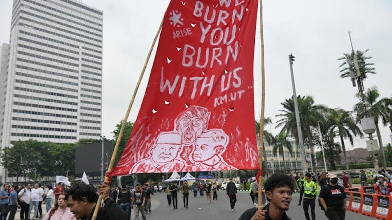 Demonstrators hold up a sign with a caricature of Indonesian President Prabowo Subianto and Donald Trump, in Jakarta, Indonesia, October 28, 2026 (AFP) Demonstrators hold up a sign with a caricature of Indonesian President Prabowo Subianto and Donald Trump, in Jakarta, Indonesia, October 28, 2026 (AFP)