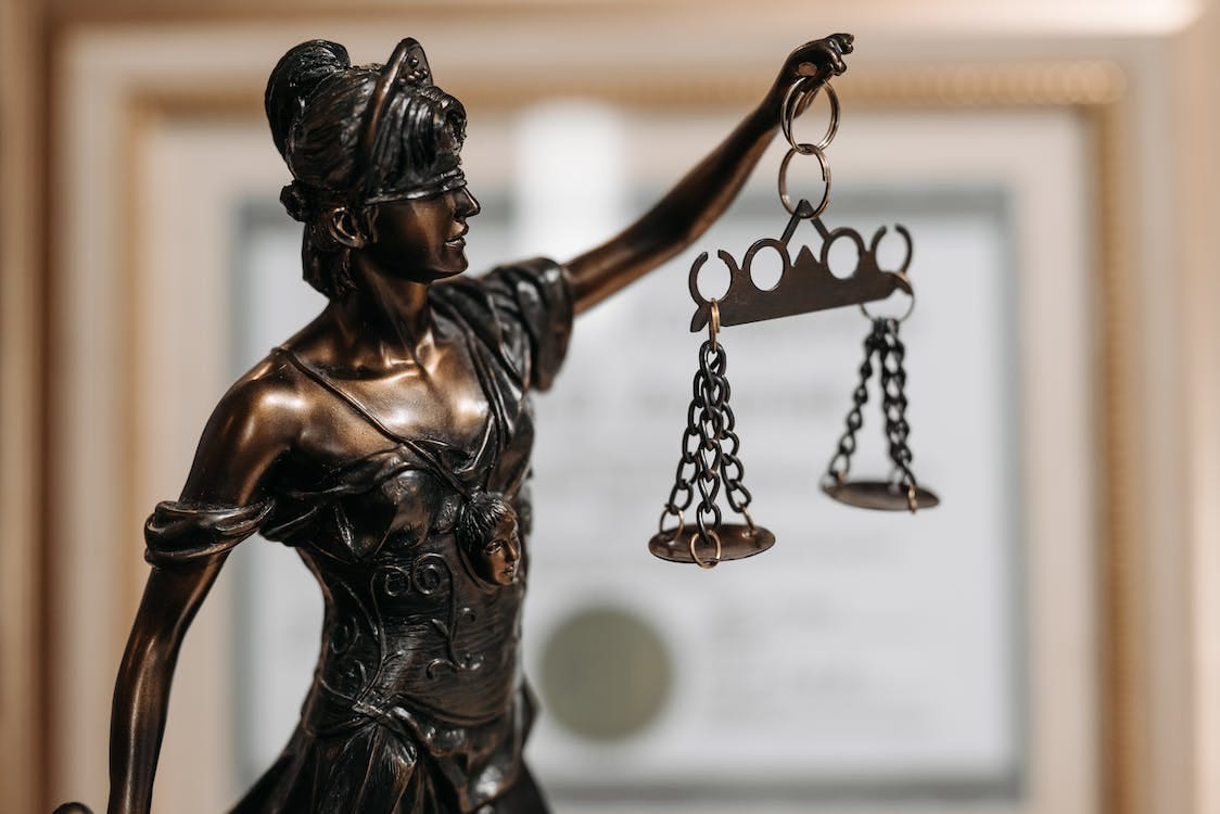 Free Black Woman Holding a Sword Figurine Stock Photo