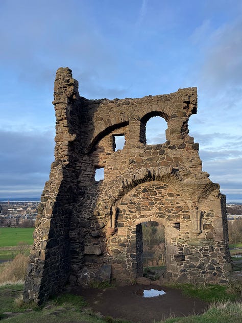a picture of witch hazel in bloom, a picture of me smiling on Arthurs seat, a cute bird in the sunshine, a ruin, a woven belt, an alder tree in winter, some first snowdrops, a little mouse plagues by concepts and my secateurs