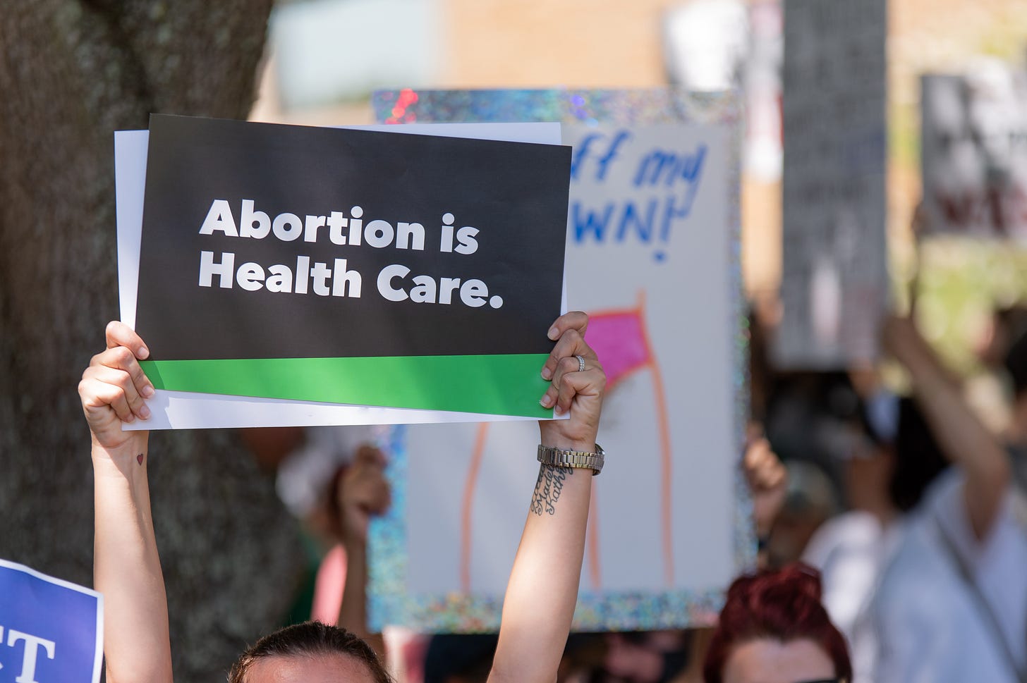 Protestor holding “Abortion is Health Care” sign