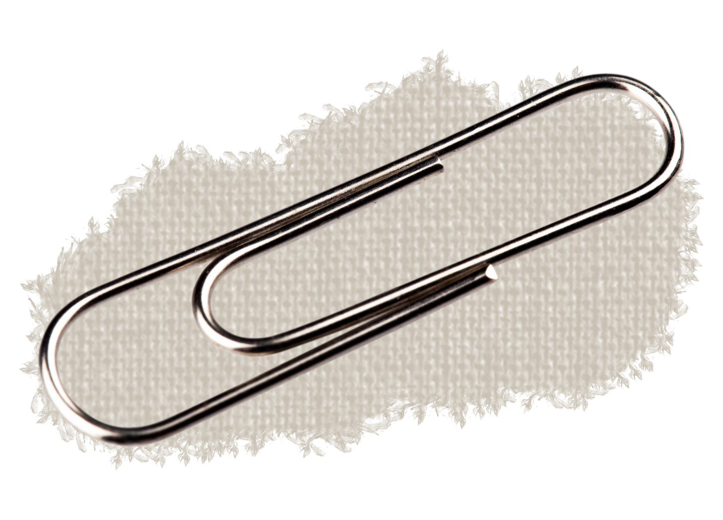 A single metal paperclip pinned to dark fabric, symbolizing Norwegian resistance in 1940