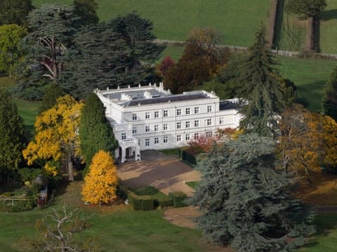 White mansion house surrounded by trees in autumn