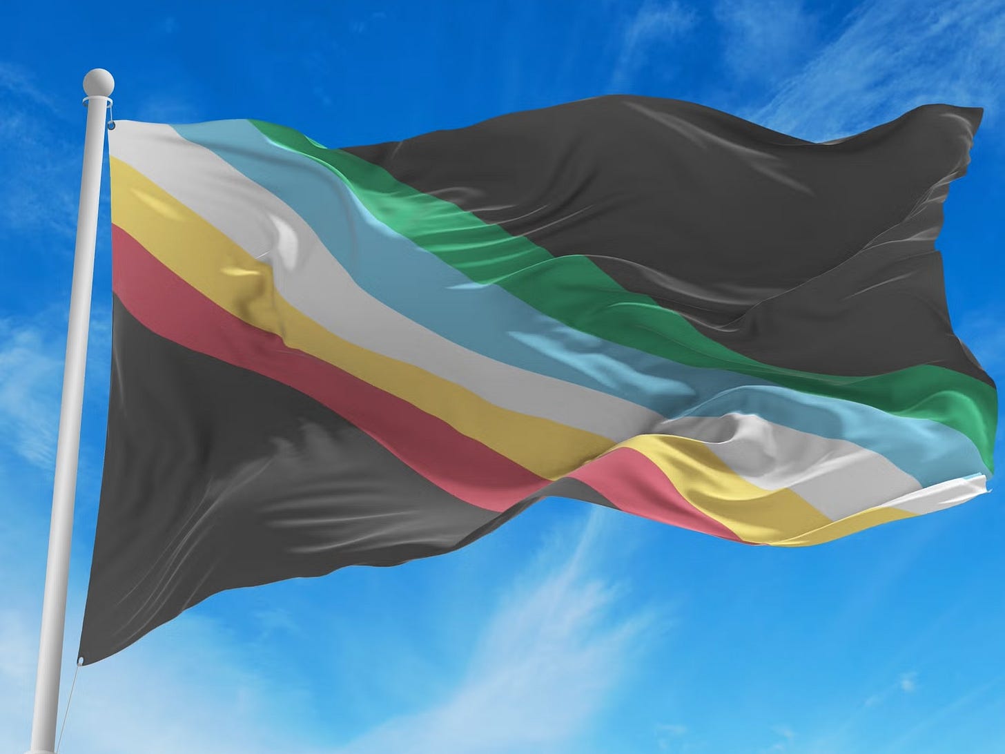 An image of the disability pride flag hanging on a white metal pole against a blue sky