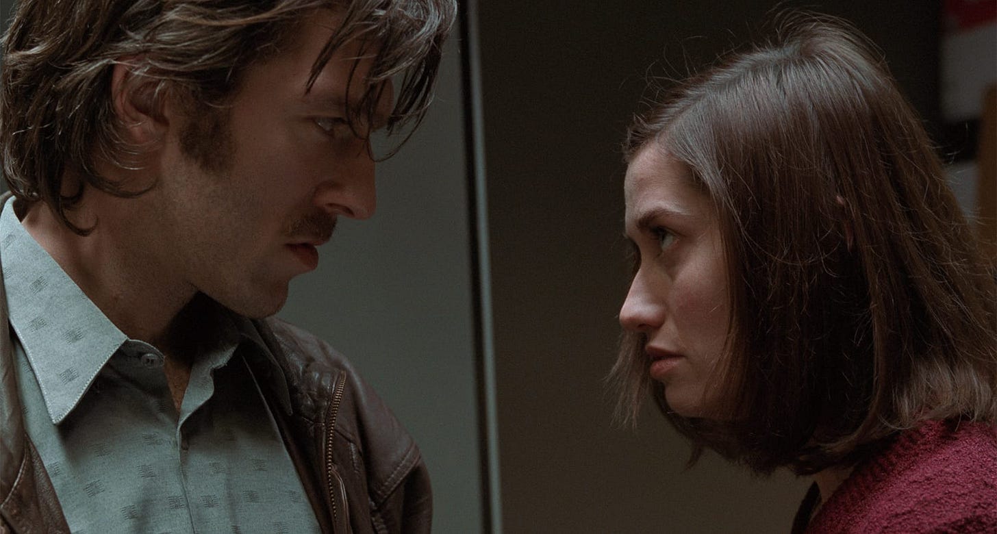 Read My Lips | Still features Vincent Cassel as Paul and Emmanuelle Devos as Carla looking into each other's eyes.