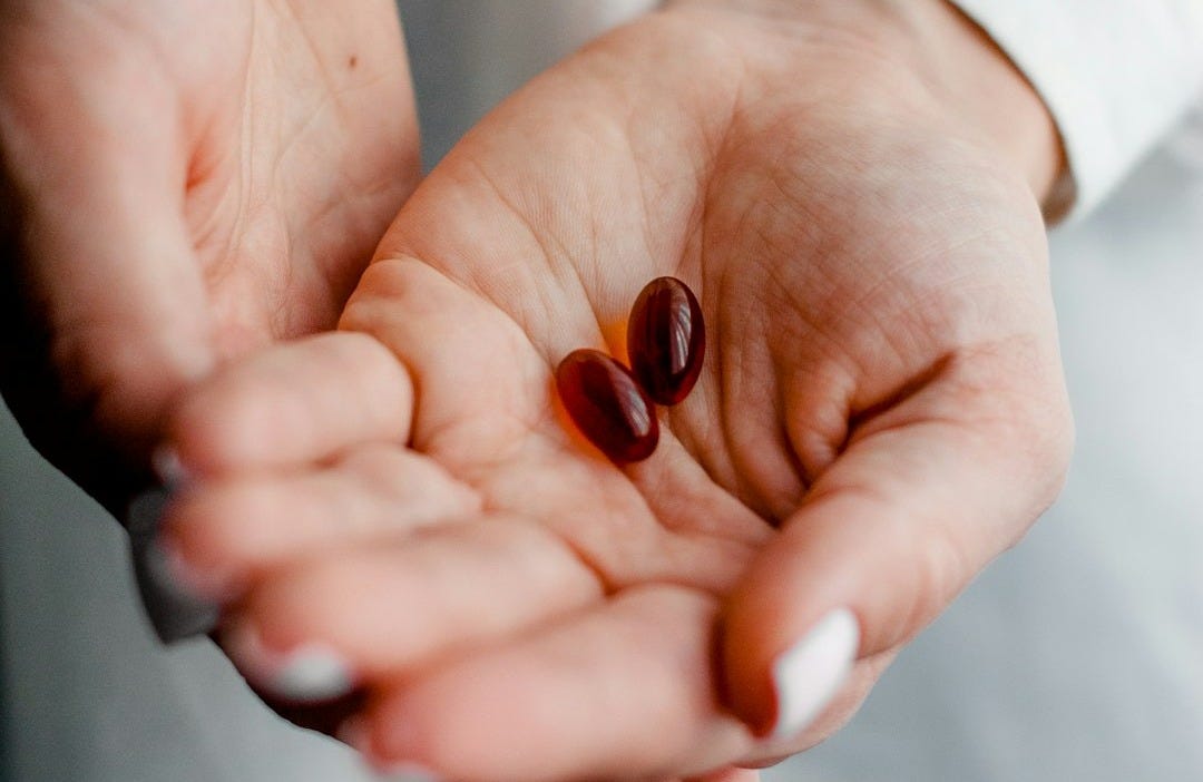 person holding brown and black round ornament