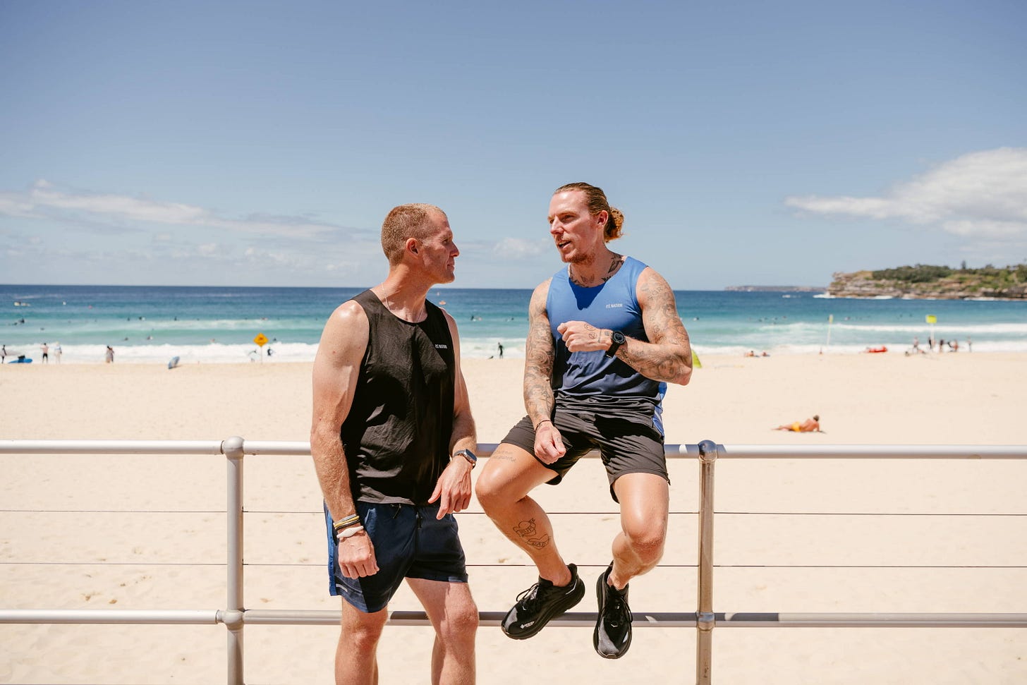 Trent Knox (l) of The 440 Run Club and Mark White (r) sitting on a fence during the 24-hour Run Grateful event in 2023