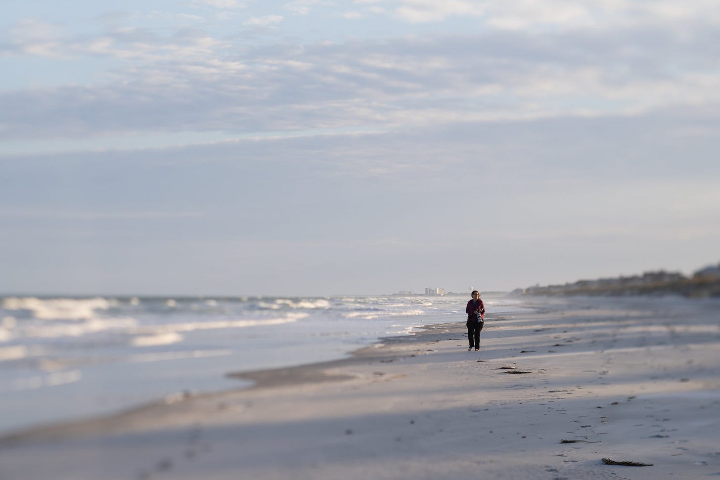 photographer on the beach with camera, figure eight island, north carolina