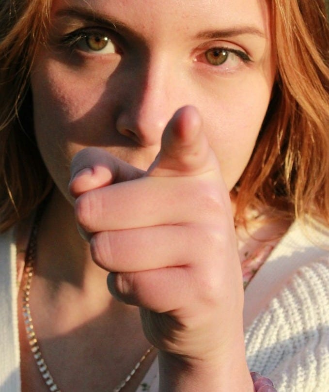 a woman with her hand on her chin