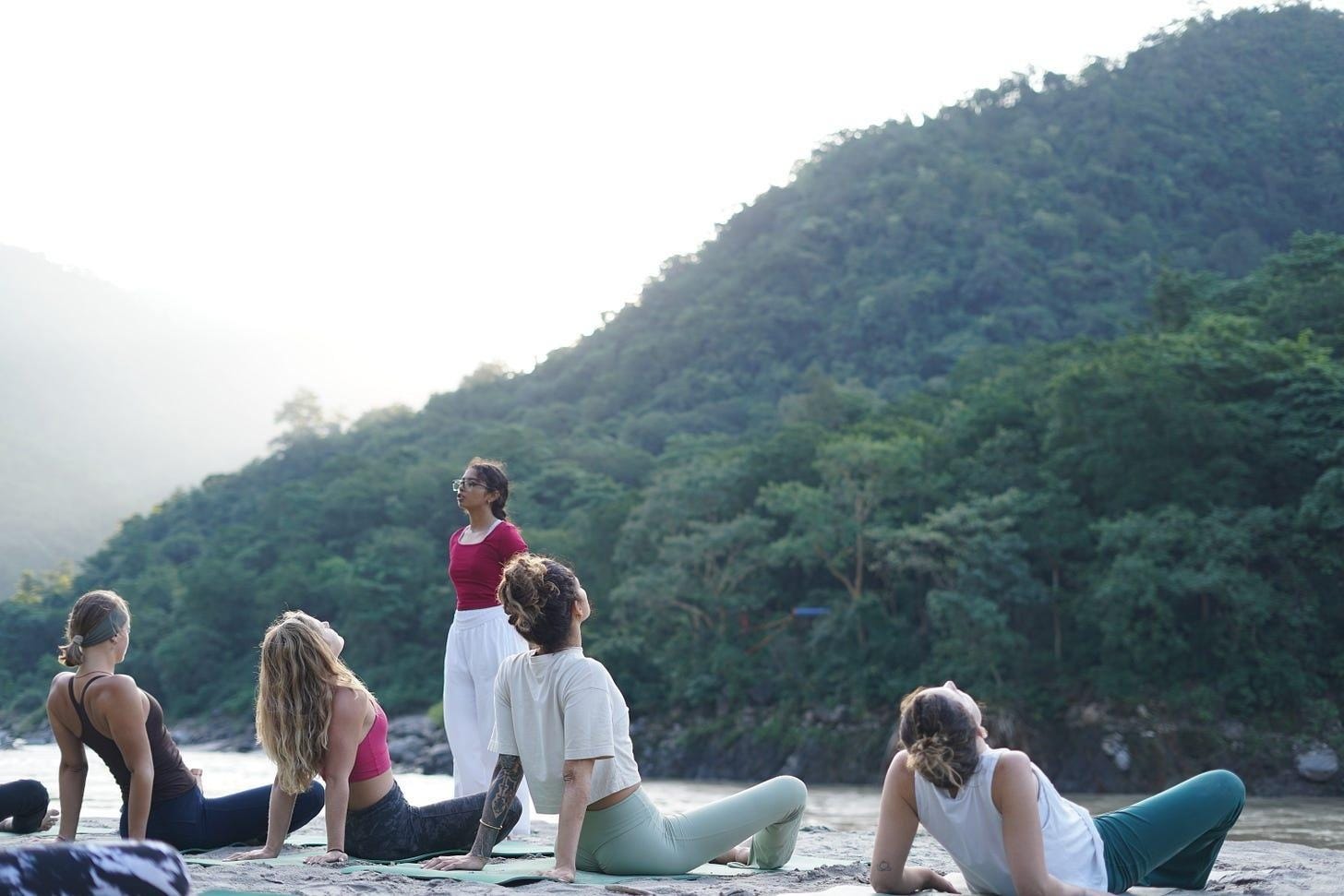 A group of people doing yoga on the beach
Description automatically generated A group of people doing yoga on the beach
Description automatically generated