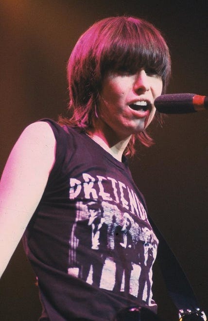 A person singing into a microphone

Description automatically generated