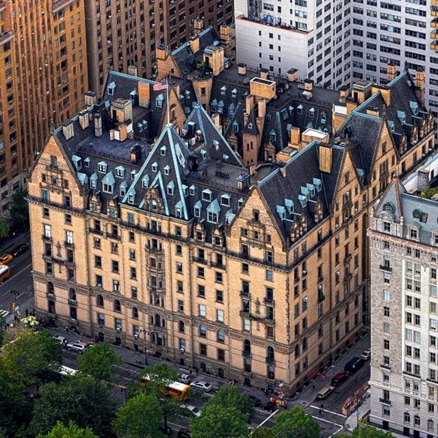 r/evilbuildings - a large building with many windows and a street with trees with The Dakota in the background