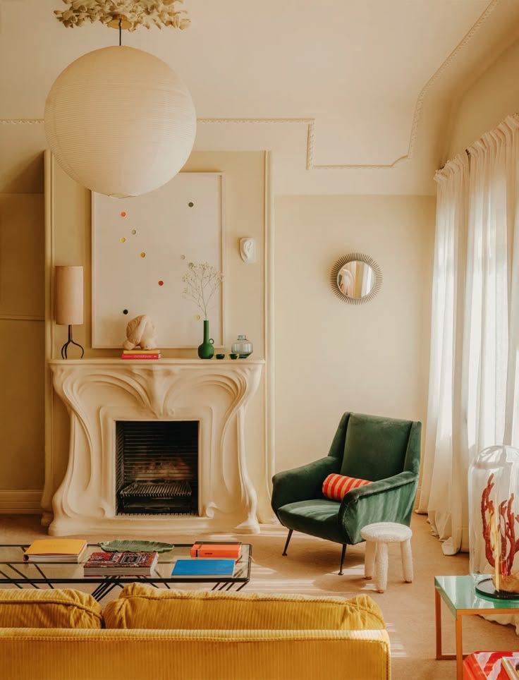 This may contain: a living room filled with furniture and a fire place in the middle of the room This may contain: a living room filled with furniture and a fire place in the middle of the room