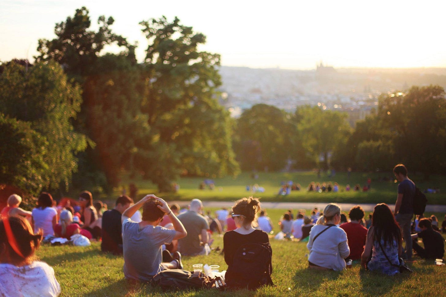 A group of people sitting in a park A group of people sitting in a park