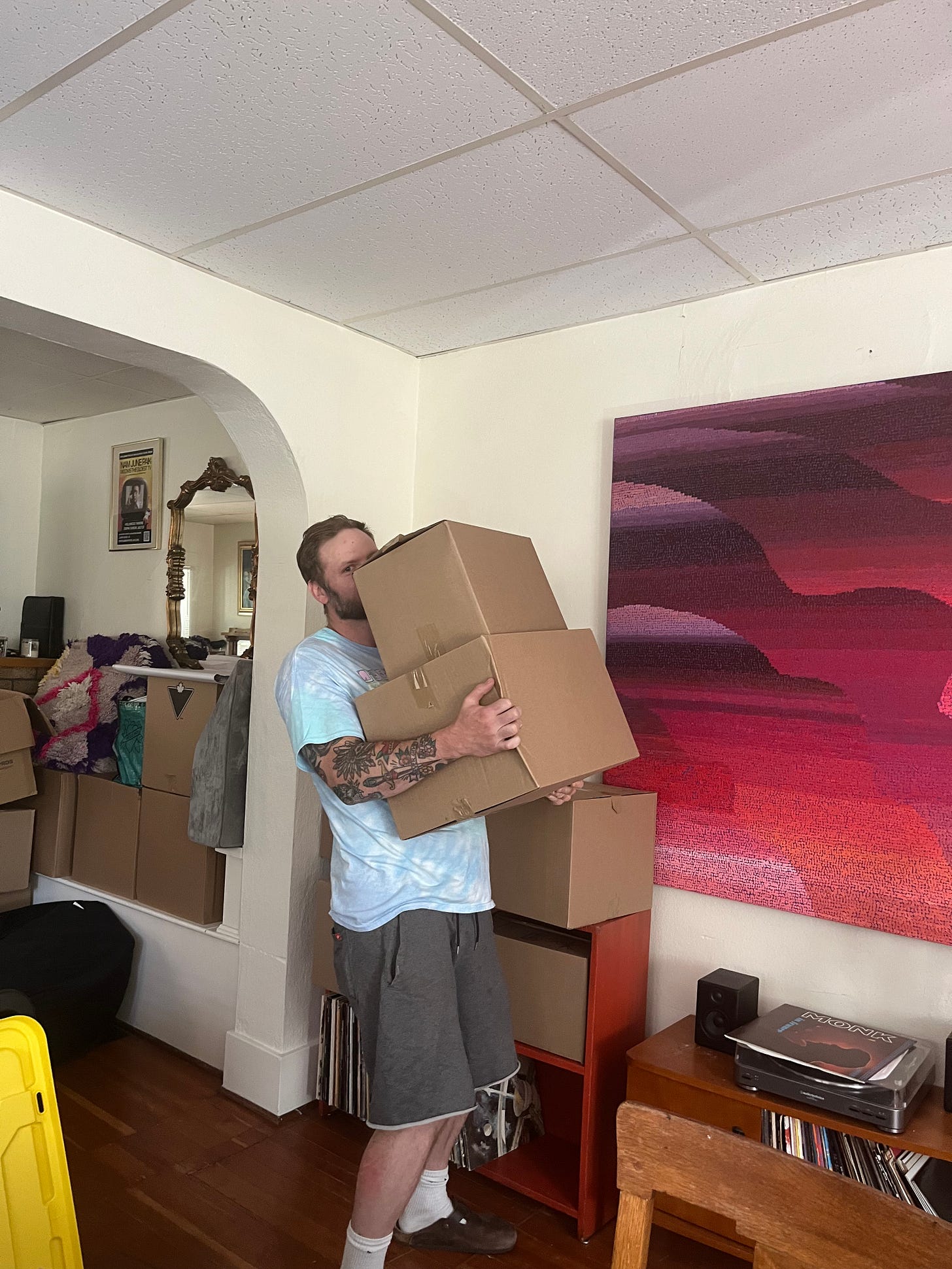 the author holds up a box in the his apartment. 