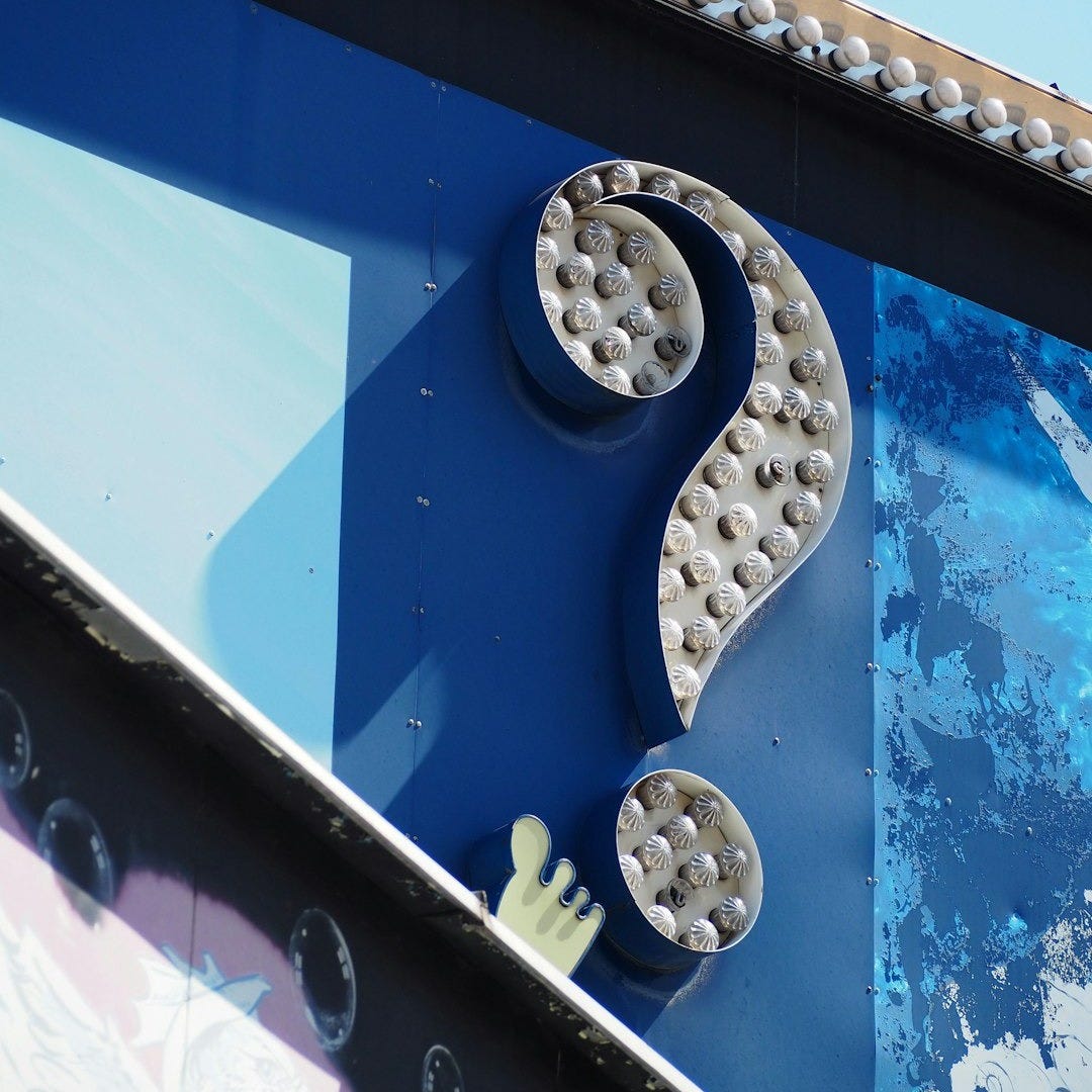 grey question mark signage grey question mark signage