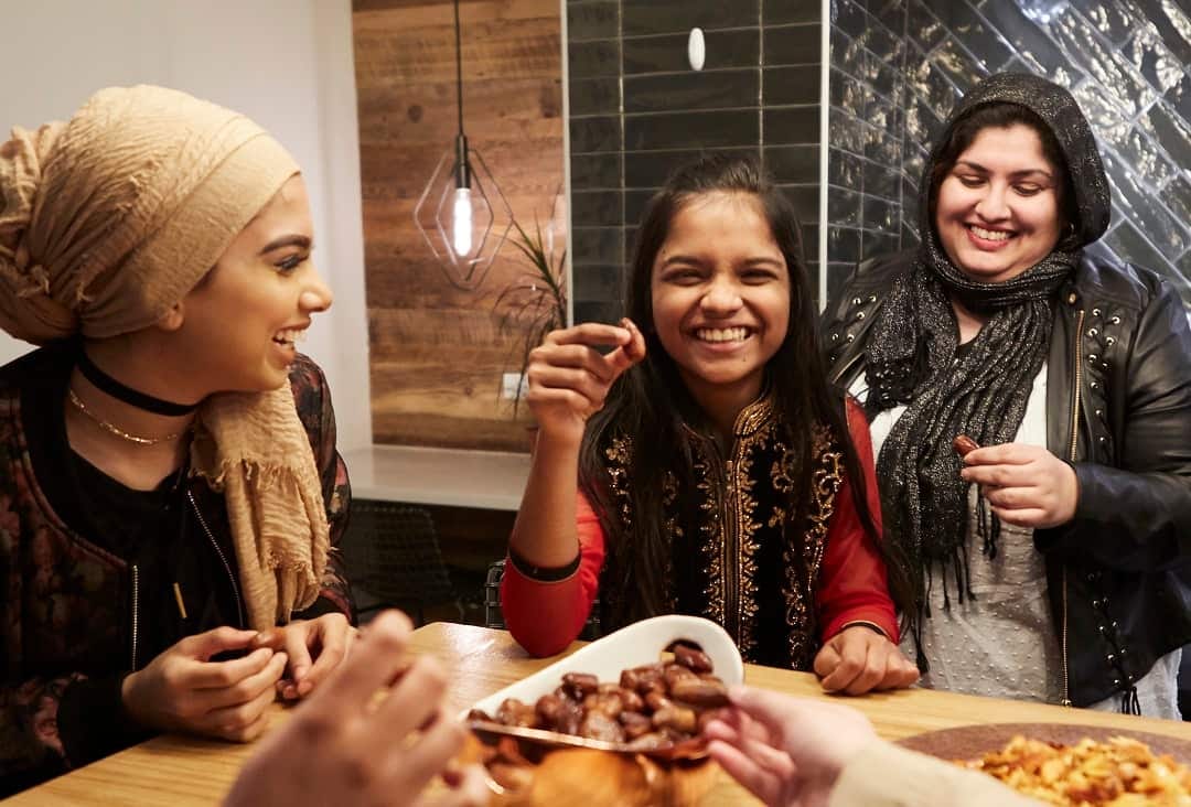 Muslim girls snack on dates.