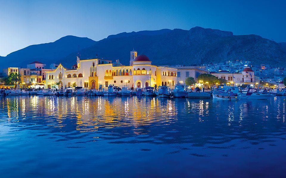 A panoramic view of Kalymnos Island, Greece, featuring rugged limestone cliffs, coastal villages and the deep blue waters of the Aegean Sea. A panoramic view of Kalymnos Island, Greece, featuring rugged limestone cliffs, coastal villages and the deep blue waters of the Aegean Sea.