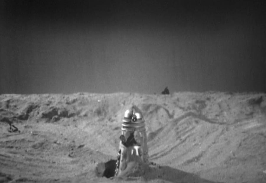A Dalek emerging from a sand dune in The Chase (1965)