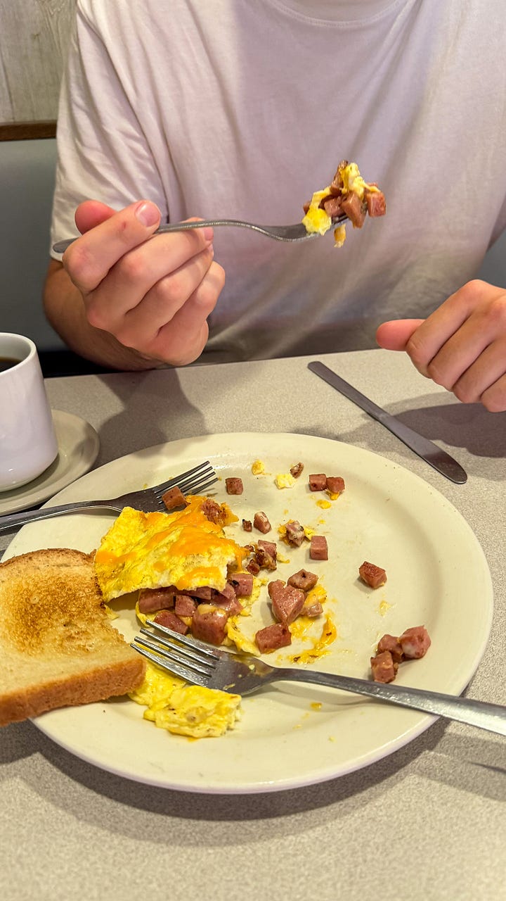 A blue banner reading "SPAM TOWN USA" next to a photo of a devoured SPAM omelet.