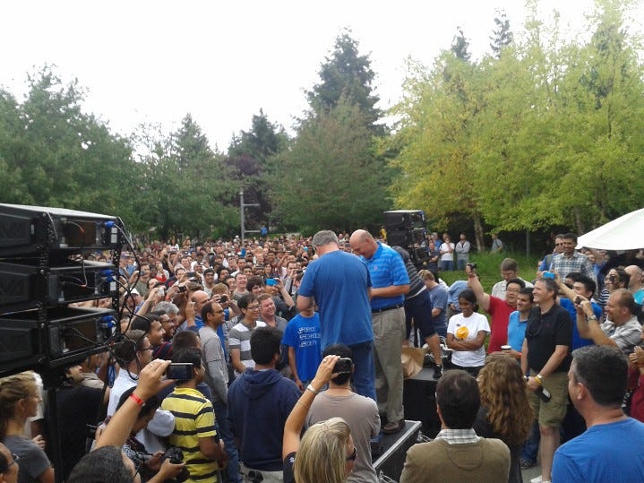 A large crowd gathered. This photo is from behind the slightly raised area. Jon DeVaan and Steve Ballmer are working on signing off on the release and Jon is about to turn on the celebratory air raid horn. A large crowd gathered. This photo is from behind the slightly raised area. Jon DeVaan and Steve Ballmer are working on signing off on the release and Jon is about to turn on the celebratory air raid horn.