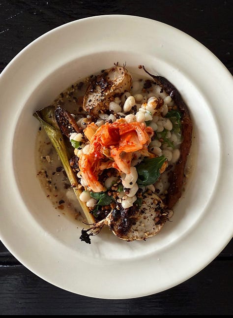 A combination of roast vegetables, tinned fish, greens, eggs, tortillas and sauce