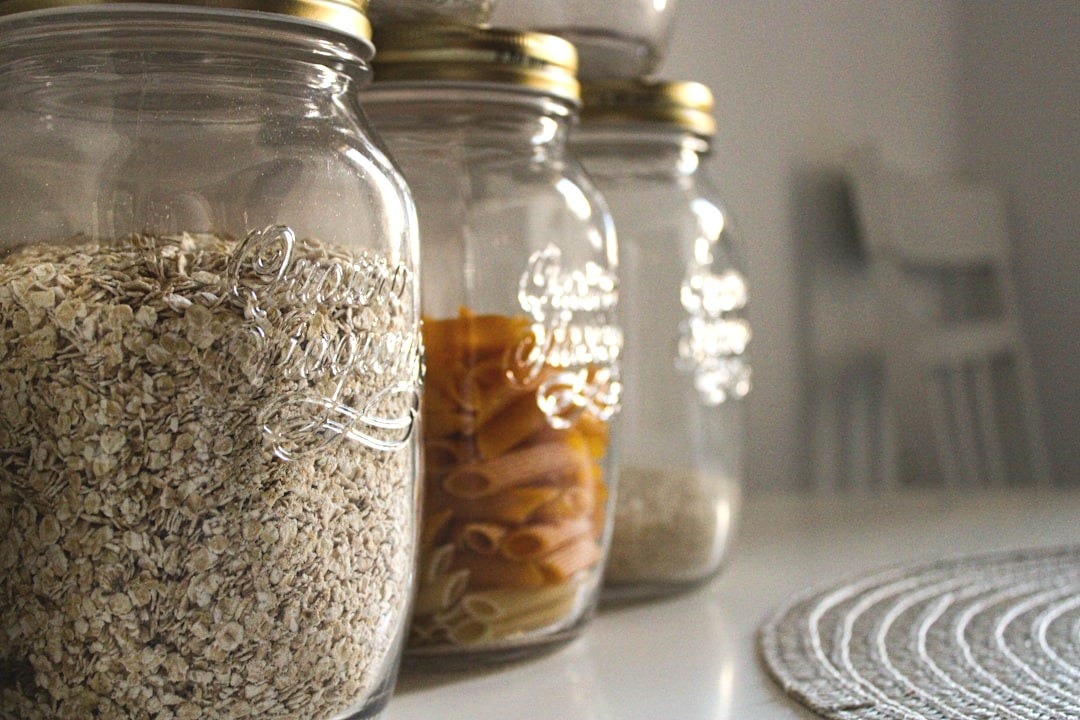 clear glass jar with brown and white beads