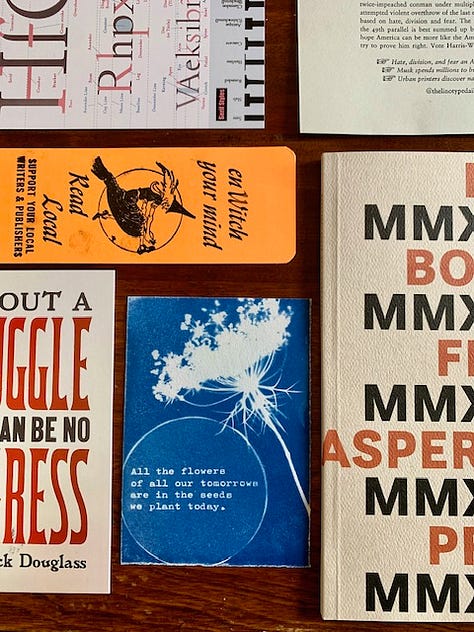 Several pieces of letterpress and cyanotype ephemera arranged on a table.