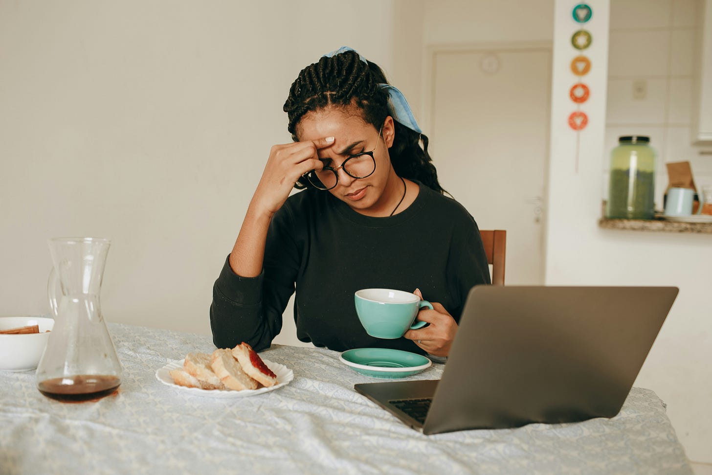 A writer is at her laptop, the coffee has run dry and so have her ideas