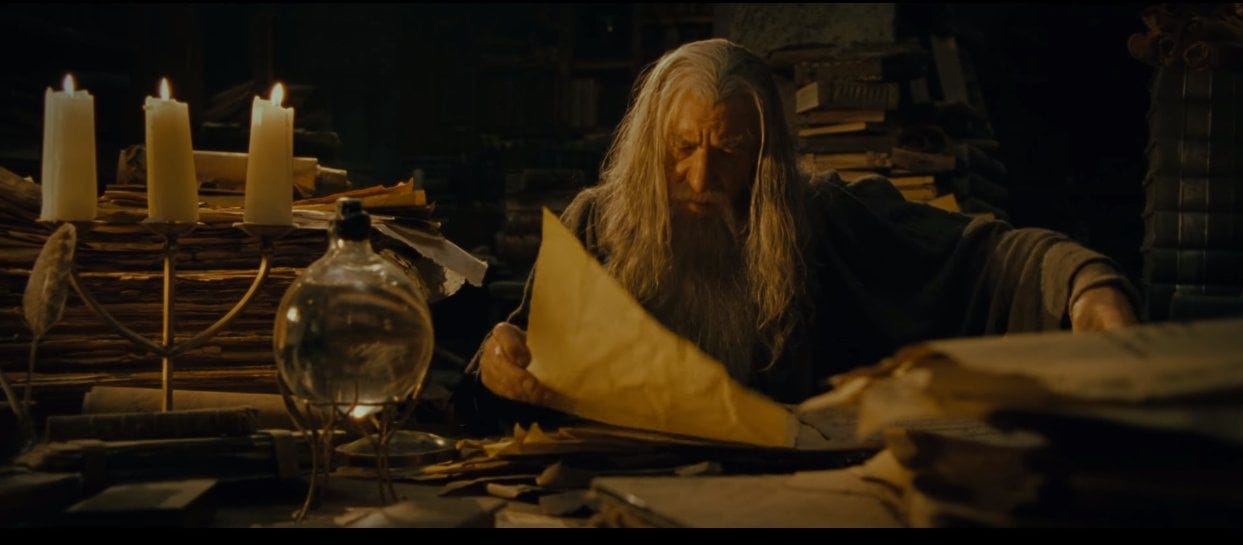 Gandalf reading in the archives of Gondor