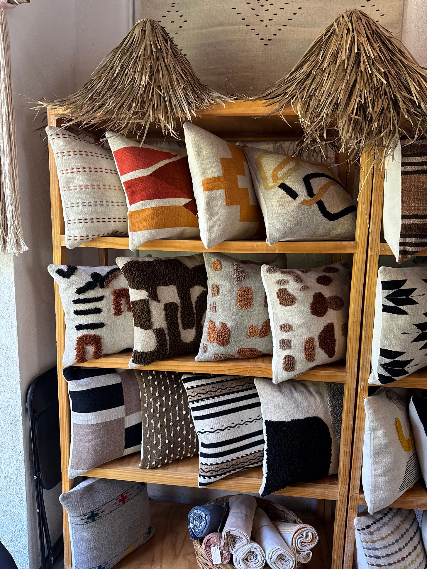 A wooden shelf covered in pillows.