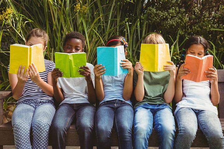 children holding books, reading books, and attending a presentation during a variety of public summer reading programs