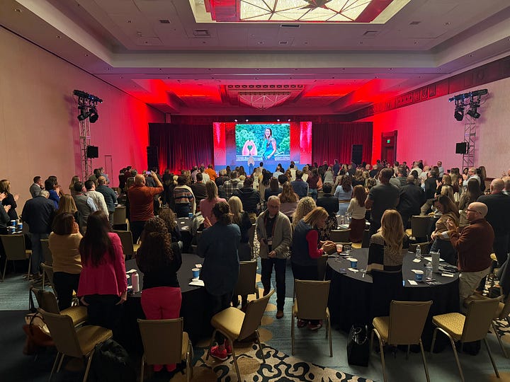 photos of gerry at national sales meetings, one on the left has a panel with gerry in the middle, and the other is a picture of gerry getting a standing ovation