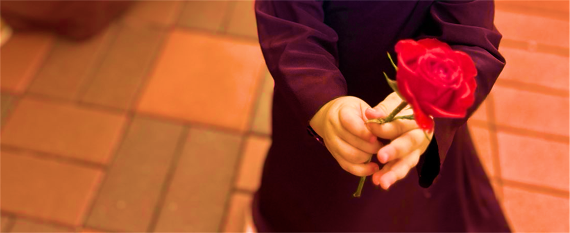 A child holding a red rose
Description automatically generated A child holding a red rose
Description automatically generated